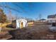 Metal storage shed with yellow door in backyard at 646 Central Nw Dr, Concord, NC 28027