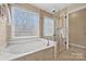 Bathroom with soaking tub and glass shower at 6700 Fairhope Ct, Charlotte, NC 28277