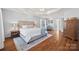 Bright bedroom with hardwood floors and access to a hallway at 6700 Fairhope Ct, Charlotte, NC 28277