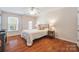 Secondary bedroom with hardwood floors and a queen bed at 6700 Fairhope Ct, Charlotte, NC 28277