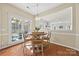 Bright breakfast nook with hardwood floors and view of backyard at 6700 Fairhope Ct, Charlotte, NC 28277