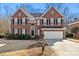 Brick two-story house with a large front yard and attached two-car garage at 6700 Fairhope Ct, Charlotte, NC 28277