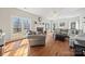 Sunlit living room with hardwood floors, fireplace, and large windows at 6700 Fairhope Ct, Charlotte, NC 28277