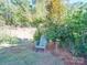 Peaceful backyard with adirondack chair and landscaping at 6706 Blackwood Ln, Waxhaw, NC 28173