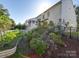 Landscaped backyard with a screened porch and lush gardens at 6706 Blackwood Ln, Waxhaw, NC 28173