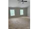 Bright bedroom with plush carpeting, neutral walls, and two large windows offering ample natural light at 6706 Blackwood Ln, Waxhaw, NC 28173
