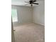 Neutral bedroom with plush carpet features natural light from the window and ceiling fan at 6706 Blackwood Ln, Waxhaw, NC 28173
