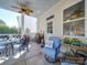 Enjoyable screened porch with seating, glass top table and ceiling fan at 6706 Blackwood Ln, Waxhaw, NC 28173