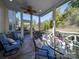 Relaxing screened porch with seating area and ceiling fan at 6706 Blackwood Ln, Waxhaw, NC 28173