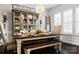 Elegant dining room featuring a rustic farmhouse table and antique cabinet at 680 Chase Ct, Fort Mill, SC 29708