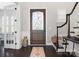 Elegant entryway with dark hardwood floors, ornate door, and staircase at 680 Chase Ct, Fort Mill, SC 29708