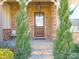 Elegant front door with stone surround and beautiful landscaping at 680 Chase Ct, Fort Mill, SC 29708