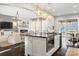 Open kitchen boasts an island with seating, stainless steel appliances, and ample counter space at 680 Chase Ct, Fort Mill, SC 29708