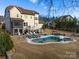 Kidney shaped pool with spa, deck, and patio furniture at 680 Chase Ct, Fort Mill, SC 29708