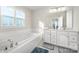 Bathroom with double vanity, soaking tub and shower at 7067 Waterwheel Sw St, Concord, NC 28025