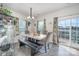 Bright dining room with a table, bench, and access to a back deck at 7067 Waterwheel Sw St, Concord, NC 28025