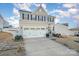 Two-story house with gray siding, white trim, and a three-car garage at 7067 Waterwheel Sw St, Concord, NC 28025