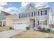 Two-story house with gray siding, white trim, and a three-car garage at 7067 Waterwheel Sw St, Concord, NC 28025