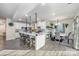 Modern kitchen with white cabinets, large island, and dining area at 7067 Waterwheel Sw St, Concord, NC 28025