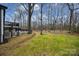 Wooded backyard with spacious lawn at 7137 Windyrush Rd, Charlotte, NC 28226