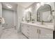 Elegant bathroom with double vanity, marble floors, and arched mirrors at 7137 Windyrush Rd, Charlotte, NC 28226