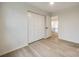 Bright bedroom featuring light wood floors and double doors at 7137 Windyrush Rd, Charlotte, NC 28226