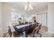 Modern dining room with stylish chandelier and a view of the kitchen at 7137 Windyrush Rd, Charlotte, NC 28226