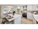 Modern kitchen with white cabinets, quartz countertops, and a large island at 7137 Windyrush Rd, Charlotte, NC 28226