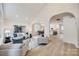 Open living room with vaulted ceilings and a view into the kitchen at 7137 Windyrush Rd, Charlotte, NC 28226