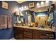 Double vanity bathroom with granite countertop and blue walls at 7236 Albemarle Dr, Denver, NC 28037