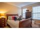 Charming bedroom with a wooden sleigh bed and striped bedding at 7236 Albemarle Dr, Denver, NC 28037