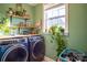 Bright laundry room with washer, dryer, and ample storage at 7236 Albemarle Dr, Denver, NC 28037