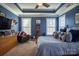 Main bedroom with blue walls, large bed, and plenty of light at 7236 Albemarle Dr, Denver, NC 28037