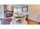 Cozy dining area with a round table and chairs near a brick fireplace at 7251 Meeting St, Charlotte, NC 28210