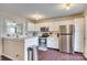 Modern kitchen with white cabinets, stainless steel appliances and breakfast bar at 7251 Meeting St, Charlotte, NC 28210