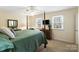 Bright bedroom featuring a four-poster bed, ceiling fan, and sunlit windows at 761 Summerwood Dr, Rock Hill, SC 29732