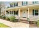 Close-up view of the inviting front porch, showcasing the decorative door, potted plants, and porch railing at 761 Summerwood Dr, Rock Hill, SC 29732