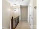 Hallway featuring decorative lighting and staircase access to the main floor at 761 Summerwood Dr, Rock Hill, SC 29732