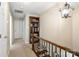 Upper hallway with a bookshelf, carpeted floors, and decorative lighting at 761 Summerwood Dr, Rock Hill, SC 29732