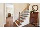 Staircase with wood steps, iron railings, and detailed trim with an adjacent cabinet at 761 Summerwood Dr, Rock Hill, SC 29732