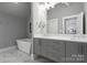 Double vanity bathroom with freestanding tub and marble floors at 7908 Rea View Ct, Charlotte, NC 28226