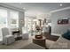 Open concept dining area with glass table, iron chairs, and kitchen views at 7908 Rea View Ct, Charlotte, NC 28226