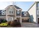 Two-story townhome with gray siding, brown garage door, and brick driveway at 7908 Rea View Ct, Charlotte, NC 28226