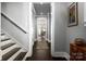 Bright entry hallway with hardwood floors, staircase, and view to the dining area at 7908 Rea View Ct, Charlotte, NC 28226