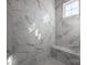 Spacious shower with marble tile and built-in seat at 7908 Rea View Ct, Charlotte, NC 28226