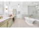 Luxurious bathroom with soaking tub, double vanity, and glass shower at 832 Heather Ln, Charlotte, NC 28209