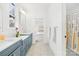 Shared bathroom with double vanity and patterned floor tile at 832 Heather Ln, Charlotte, NC 28209