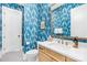 Modern bathroom with blue patterned wallpaper and a floating vanity at 832 Heather Ln, Charlotte, NC 28209