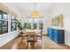 Bright dining room with round table, four chairs, and blue buffet at 832 Heather Ln, Charlotte, NC 28209