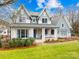 Beautiful two-story home with a covered porch and landscaped yard at 832 Heather Ln, Charlotte, NC 28209